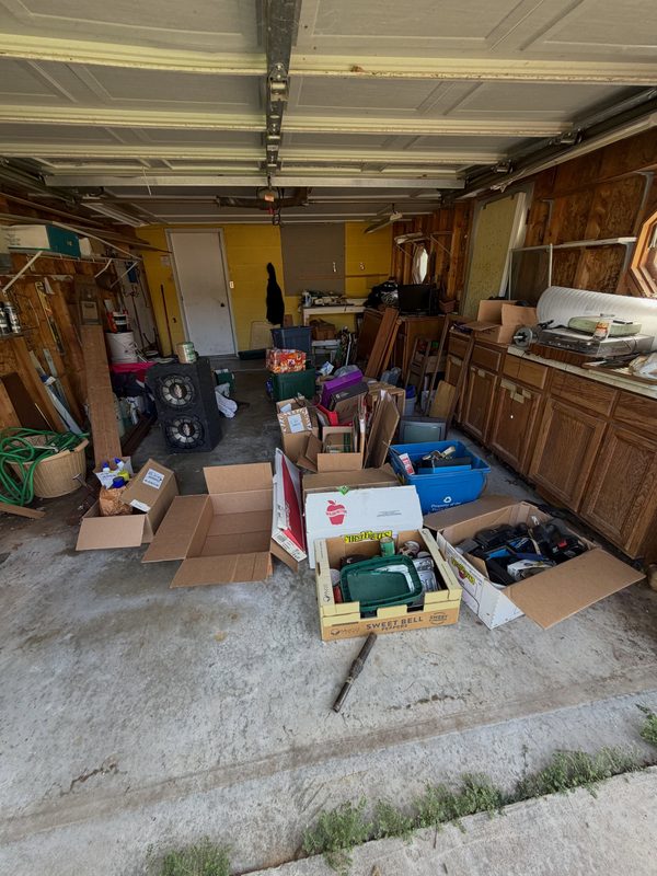 Garage during a cleanout with packed boxes staged on the floor