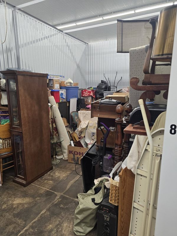 Storage unit filled with furniture, boxes and household items